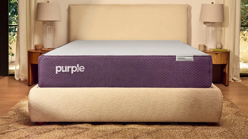Purple Restore Hybrid mattress on an upholstered bed